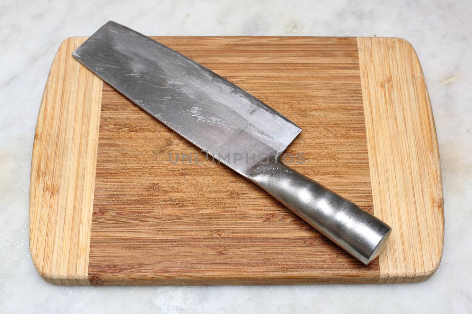 kitchen knife on cutting board by leungchopan