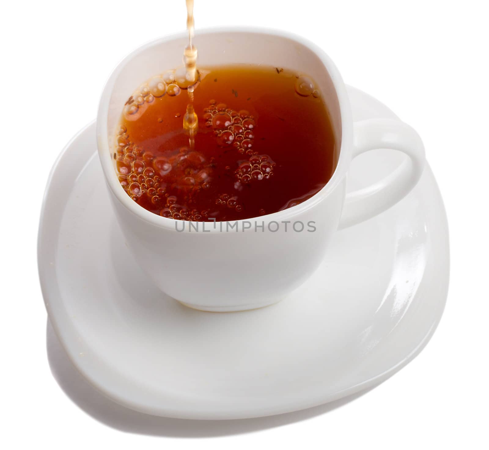 filling cup of rooibos tea, isolated on white