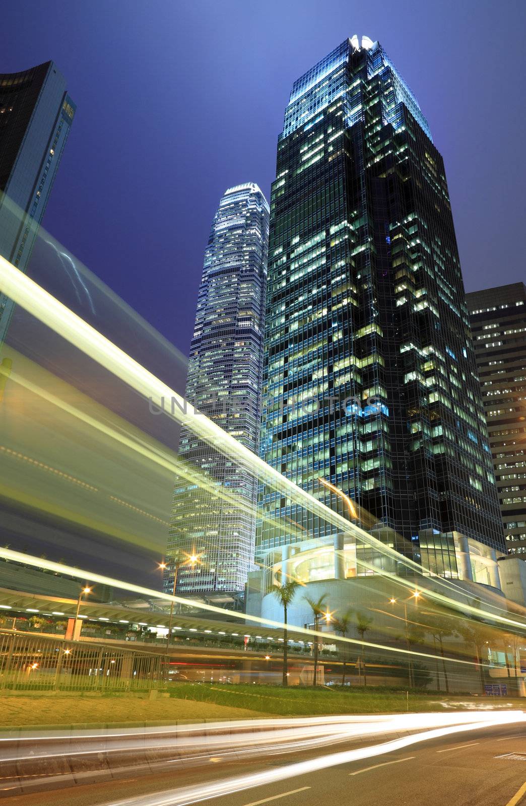 Skyscraper with traffic light and cars motion blurred in Hong Kong