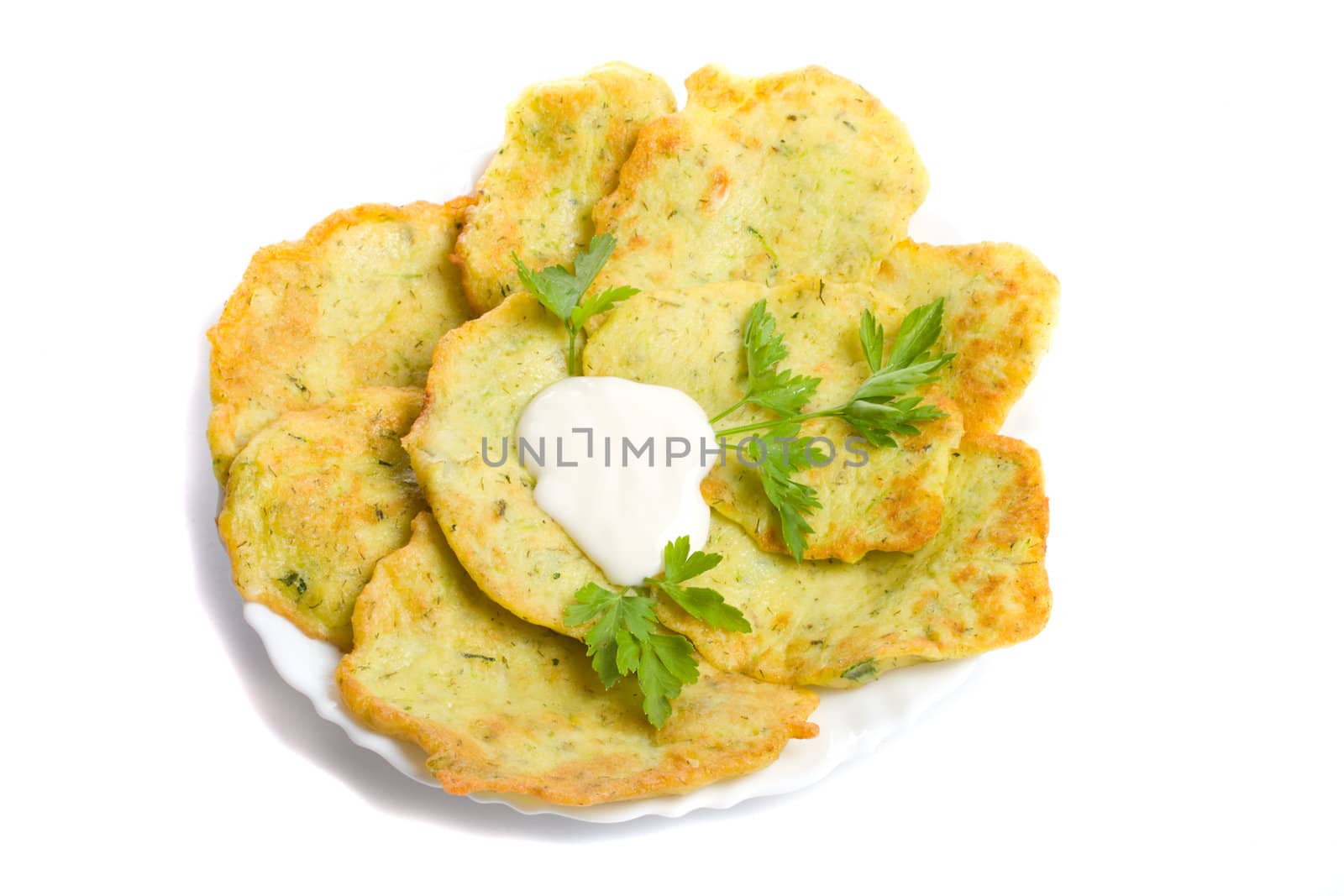 close-up pancake from marrow with parsley on plate, isolated over white background