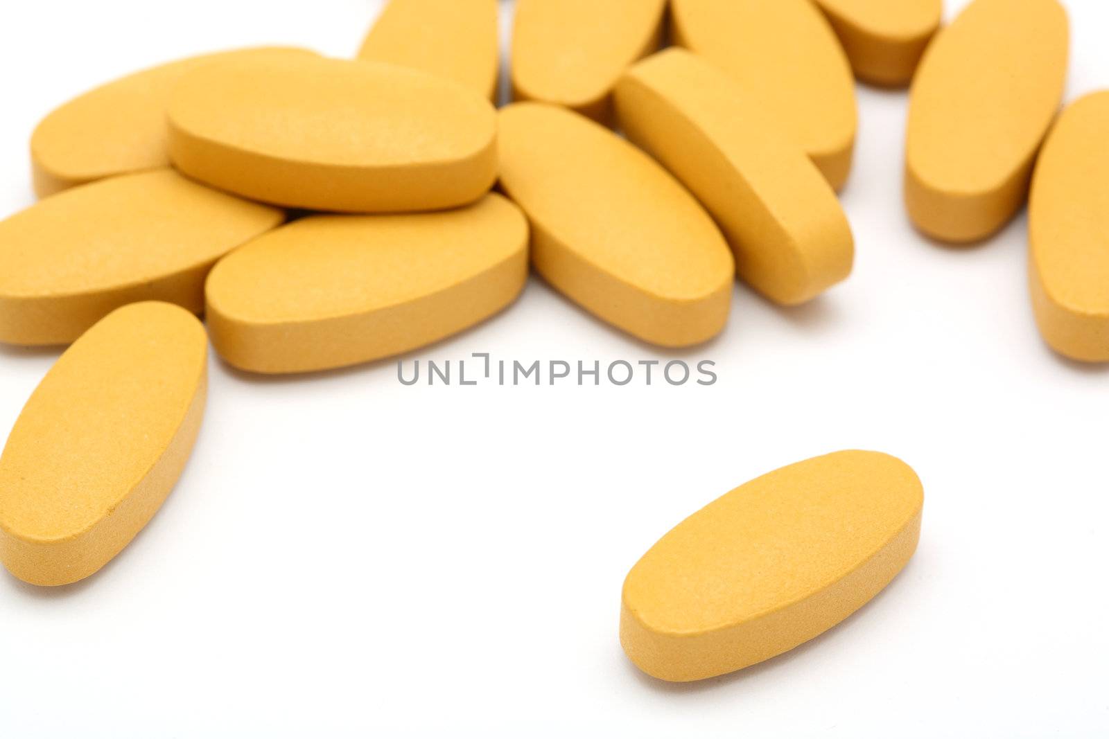 pills spilled on a white background