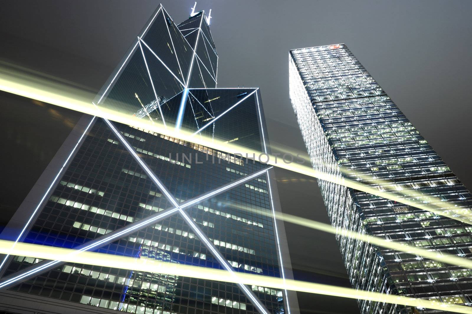 Skyscraper with traffic light and cars motion blurred in Hong Kong