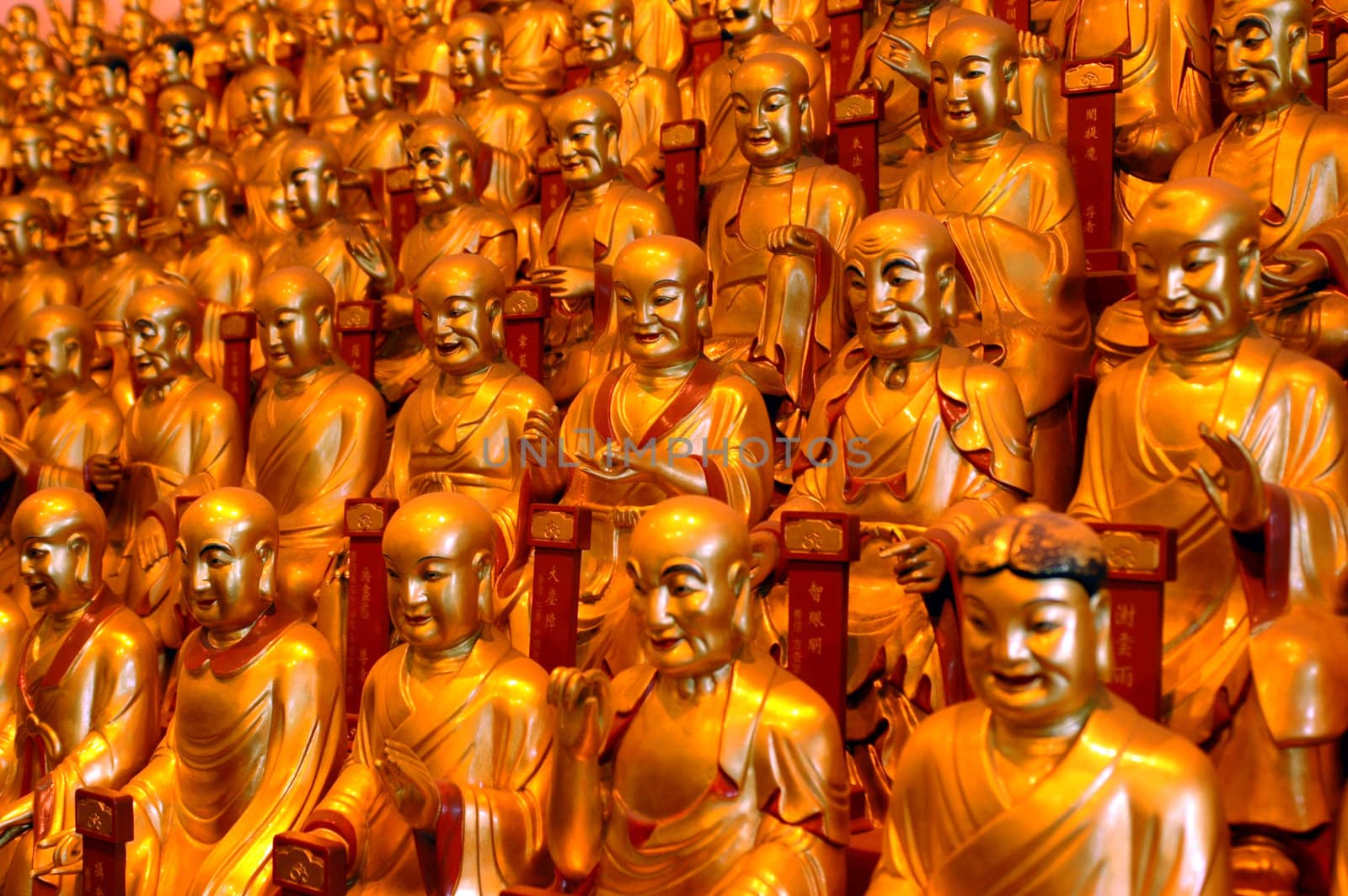 China, Shanghai city. Longhua Temple. Hundreds of golden buddhas sculptures having gathering inside temple.