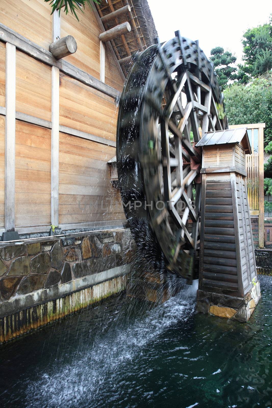 a wooden waterwheel is rotating