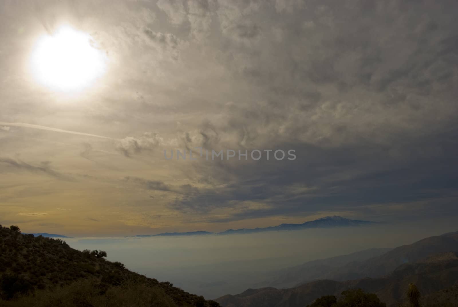 Mountain rises above thick fog