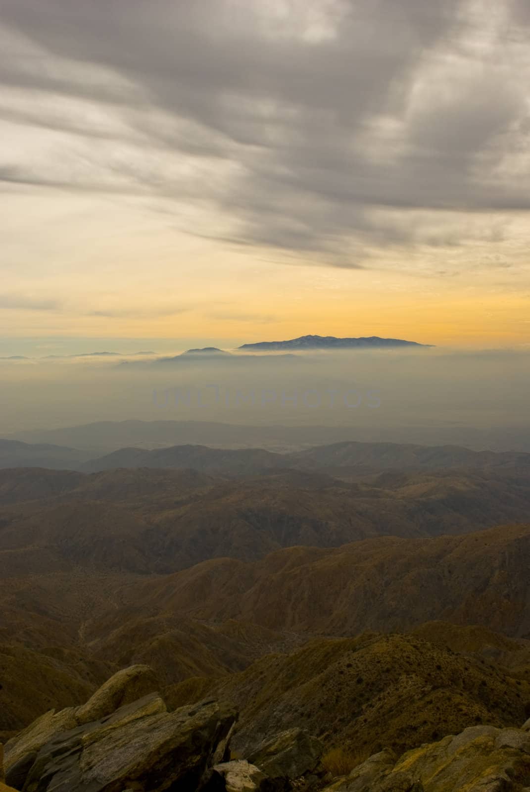 Mountain rises above thick fog