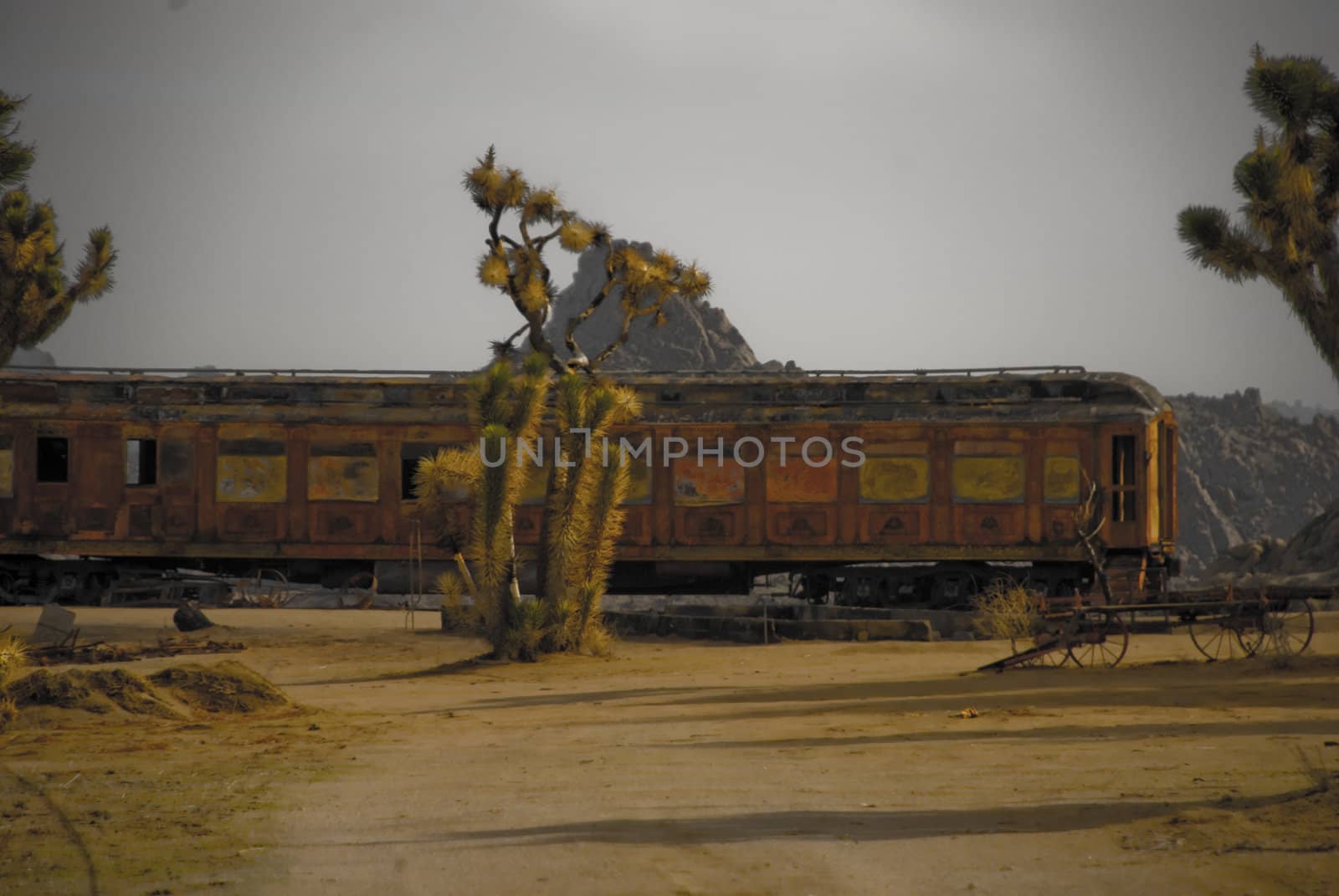 Abandoned train cabin on a track in the desert