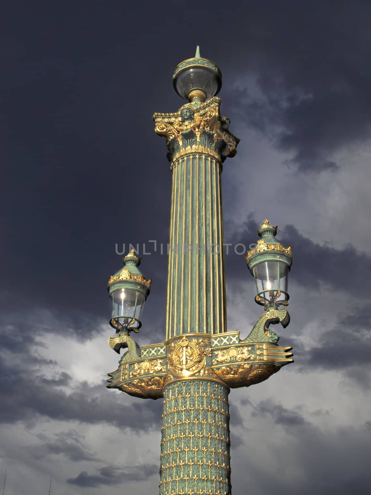An outdoor golden post lamp at the Concorde square in Paris