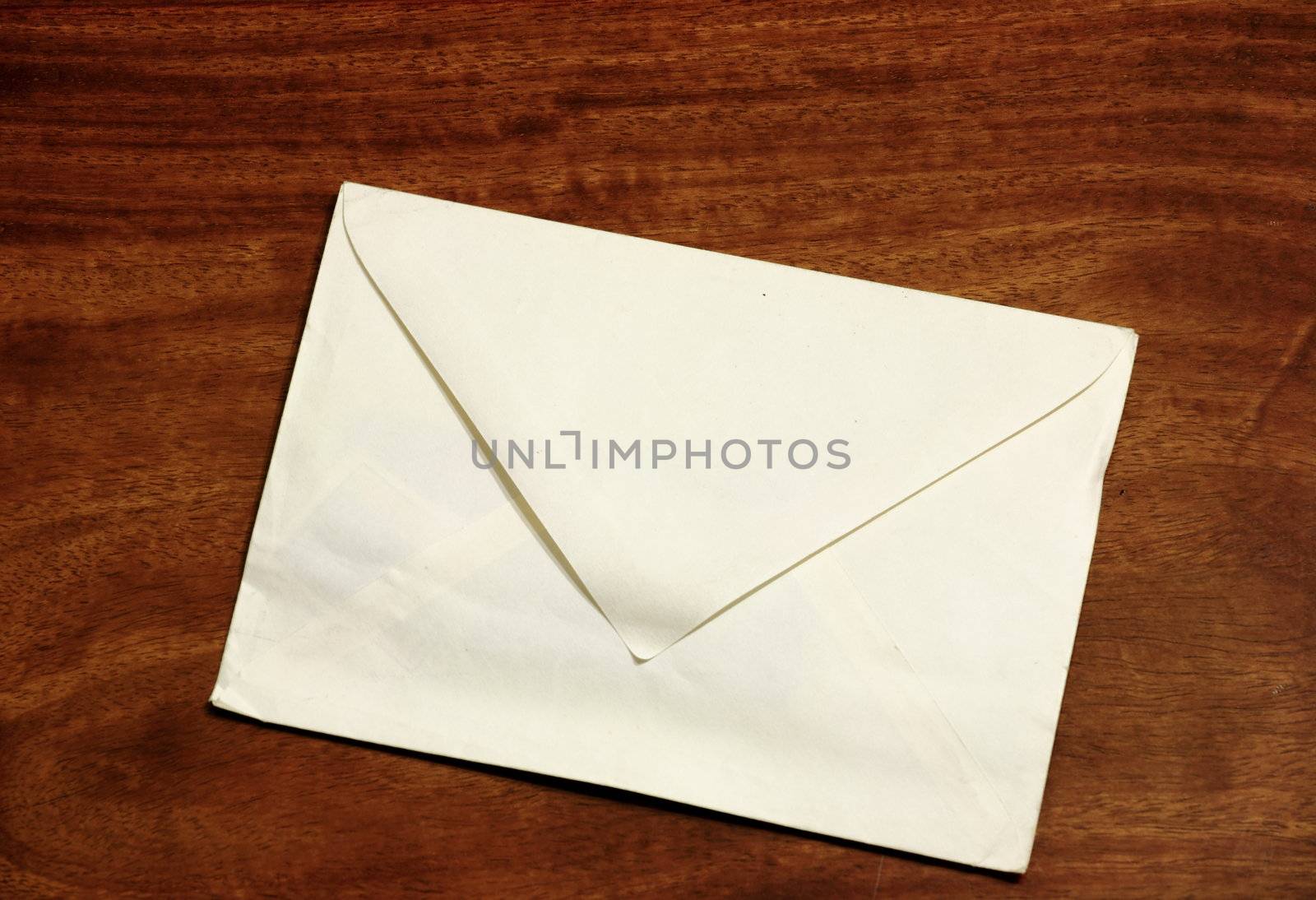 old envelope on wooden background by leungchopan