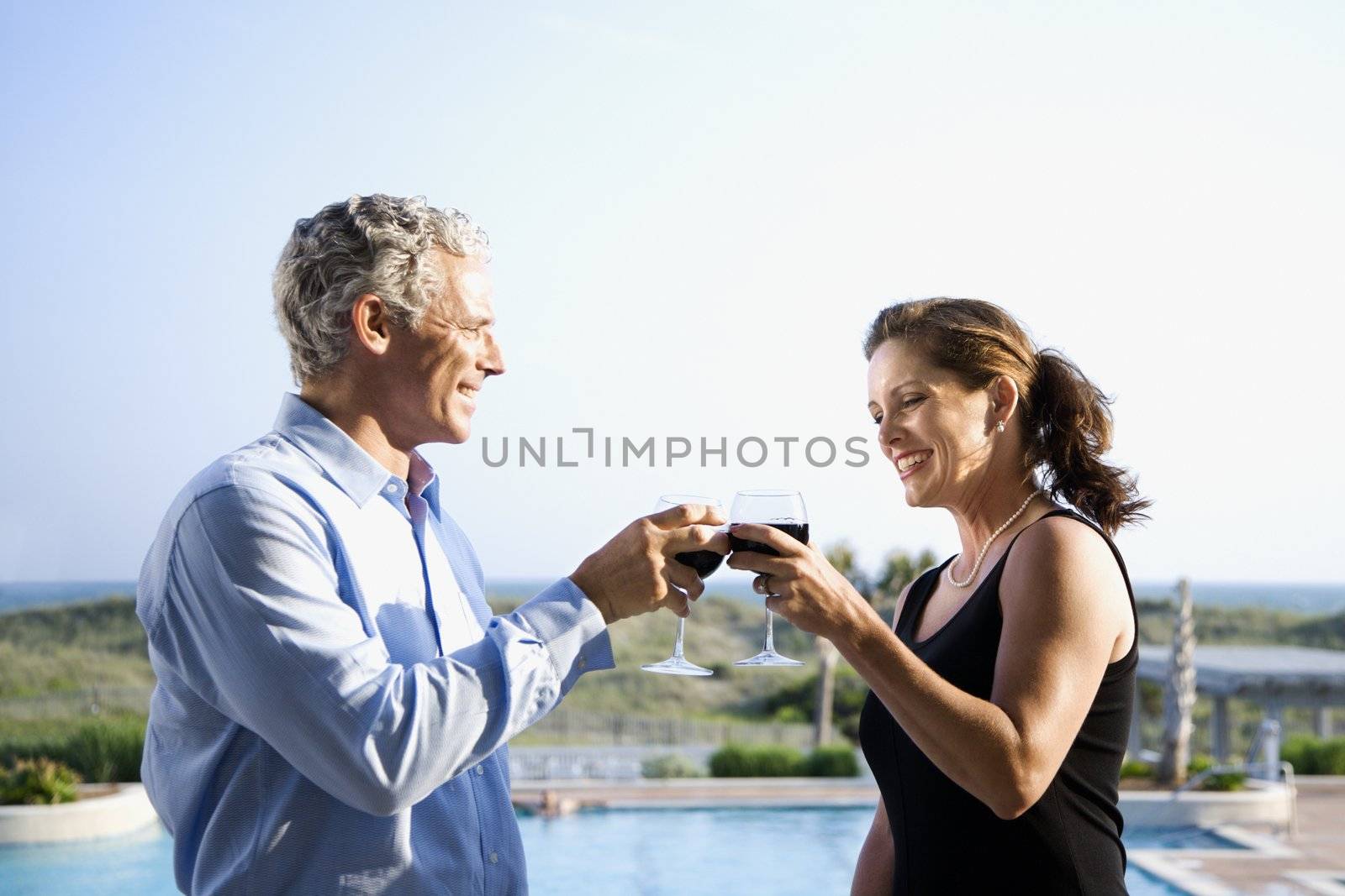 Couple toasting. by iofoto