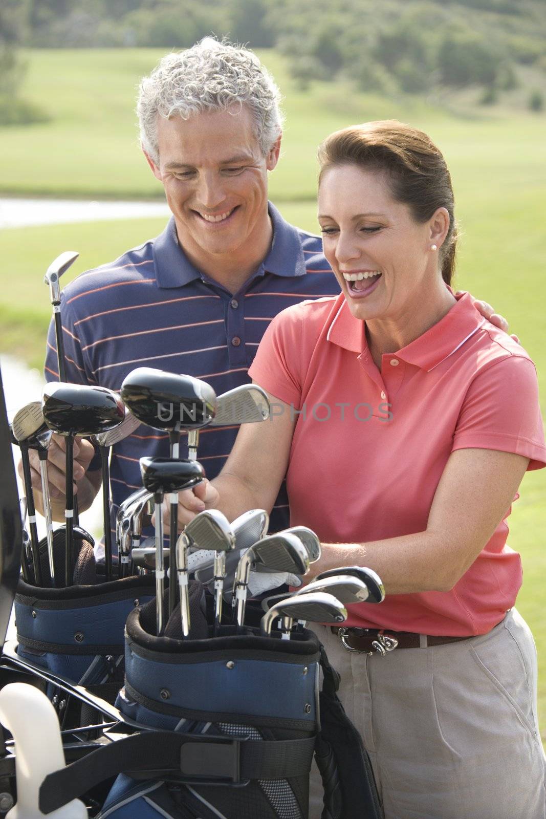 Couple playing golf. by iofoto