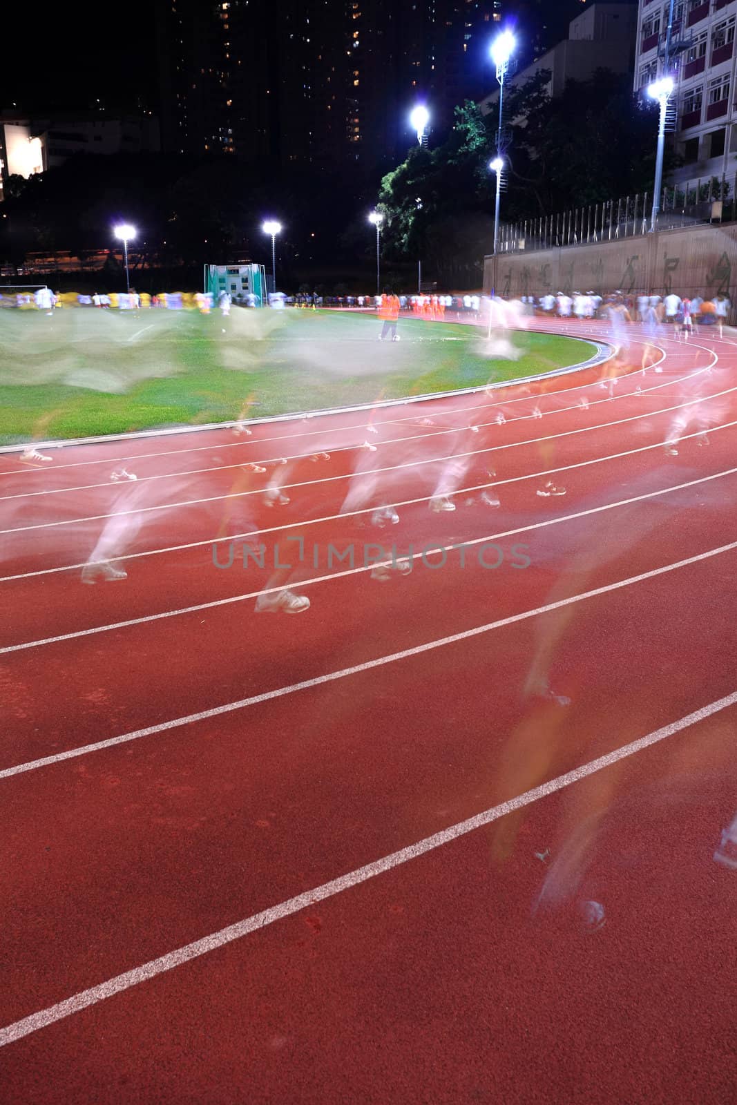 Running tracks in a stadium, with human running blur