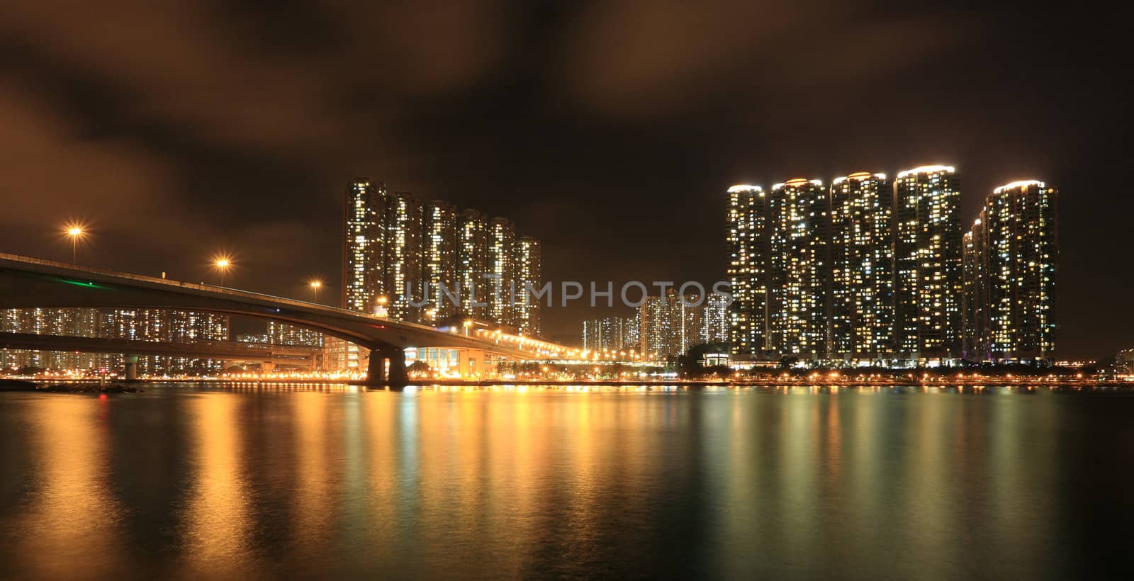 Business Towers and Residential Apartment Buildings in Hong Kong at night by leungchopan