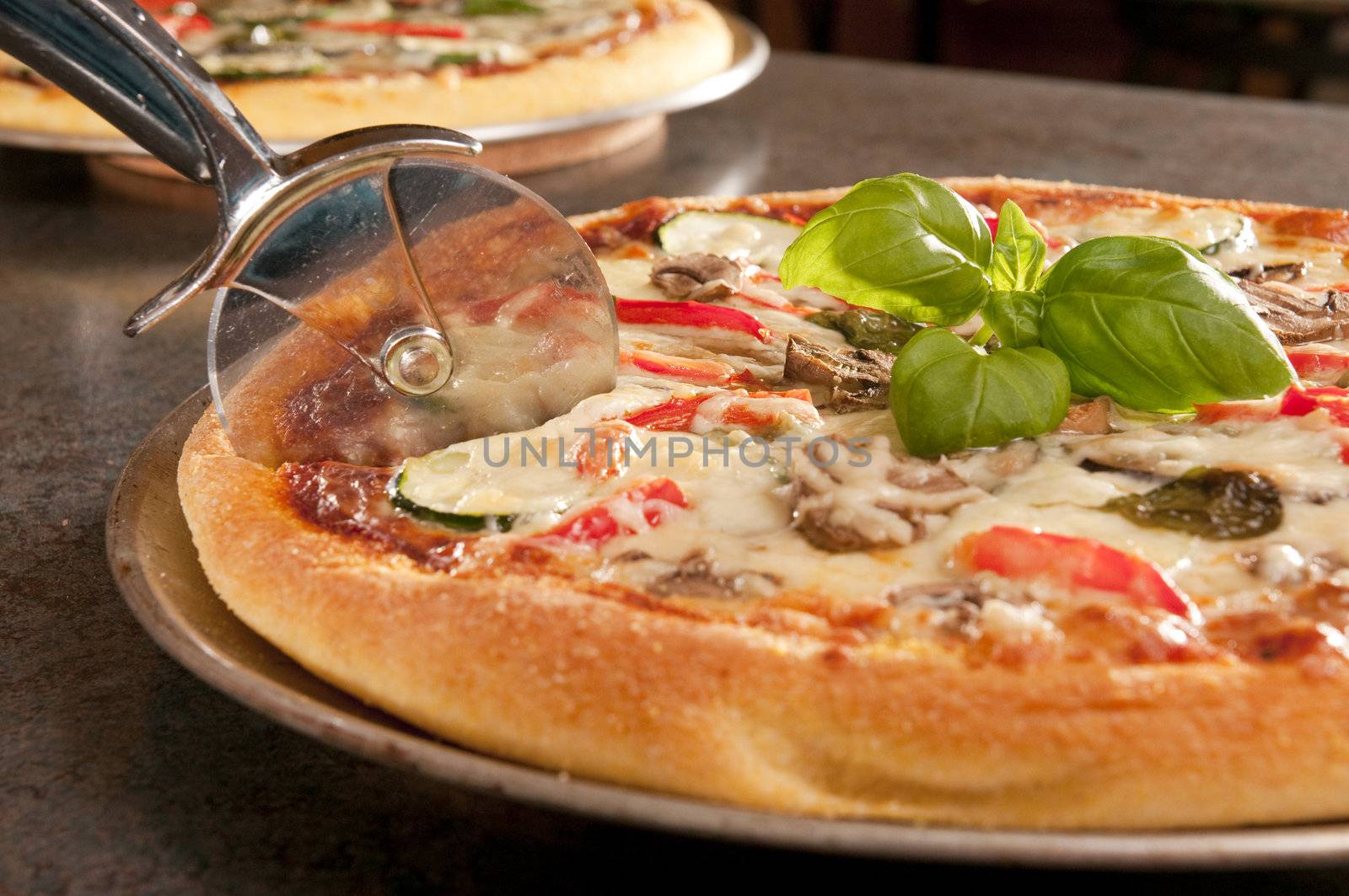 Cooked pizza with eggplant and zucchini topping