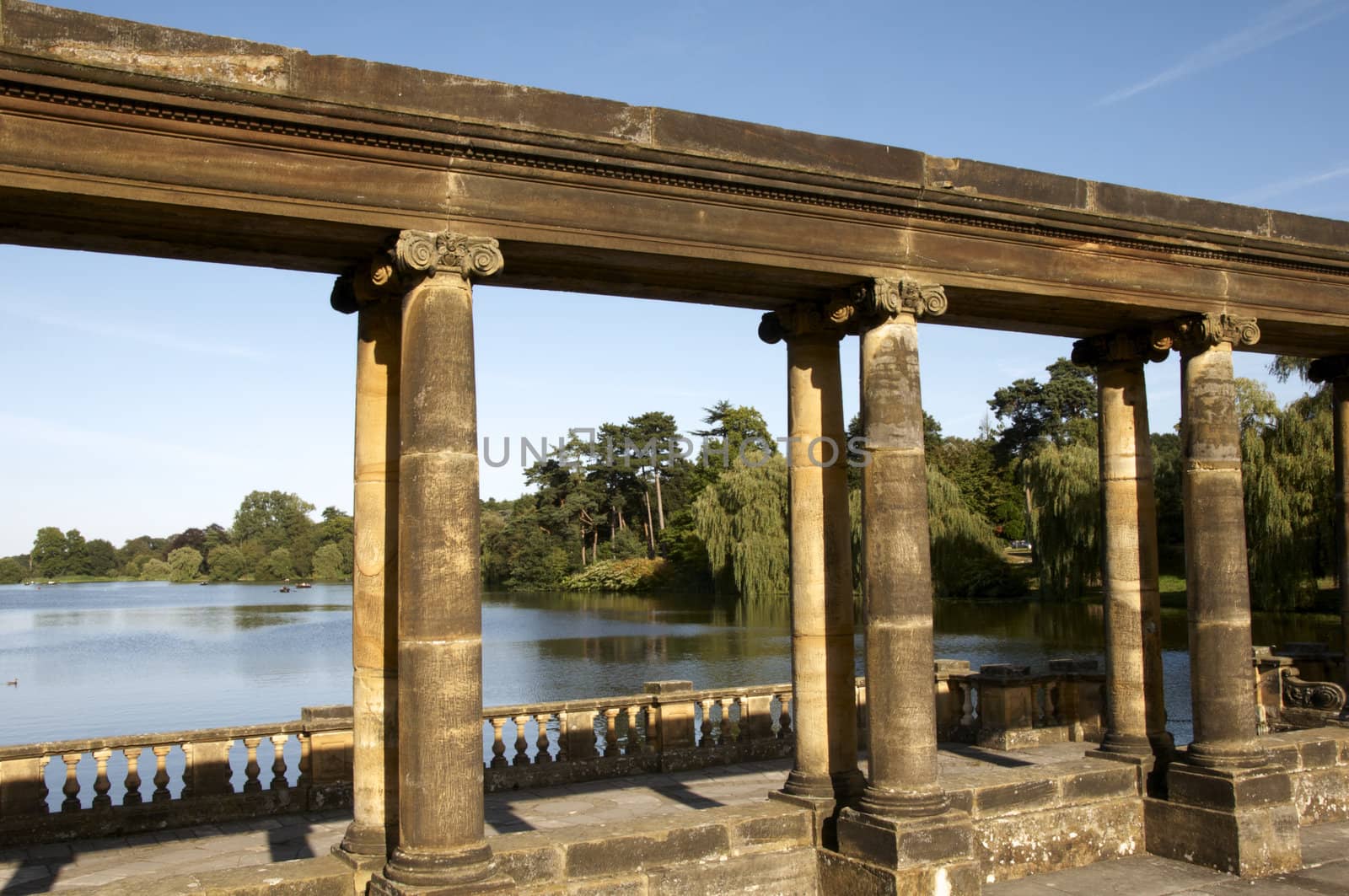 A row of column's with a lake in the background