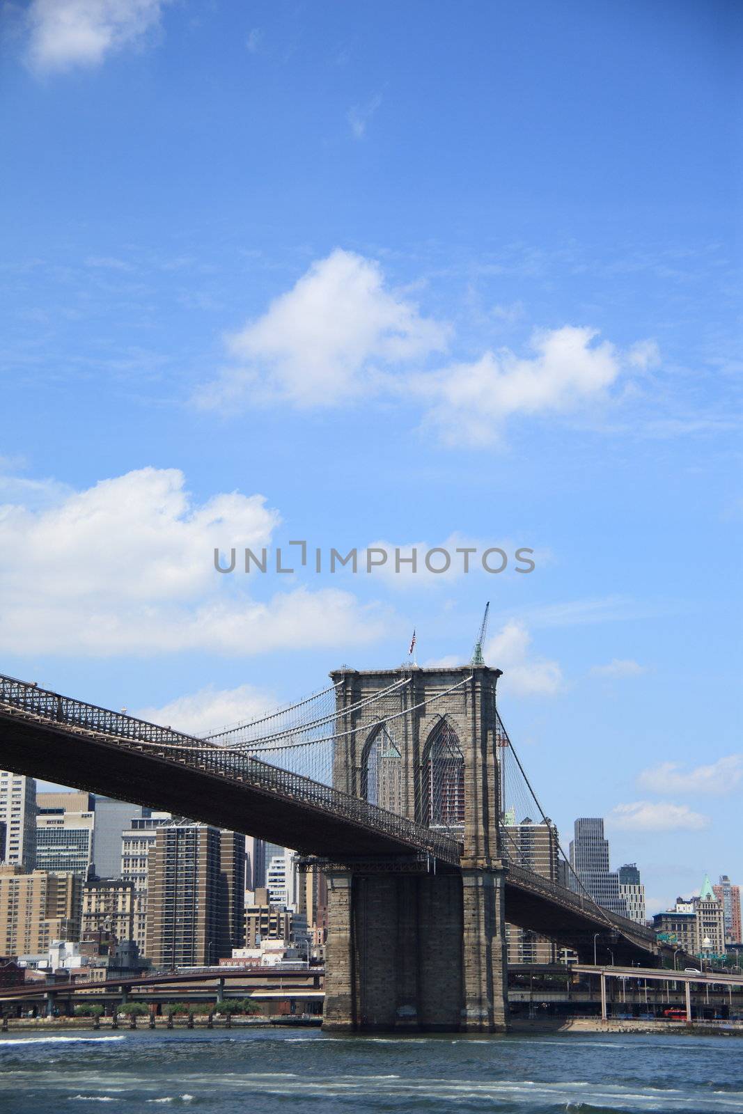 Brooklyn Bridge arches and steel cables across the East River to Manhattan