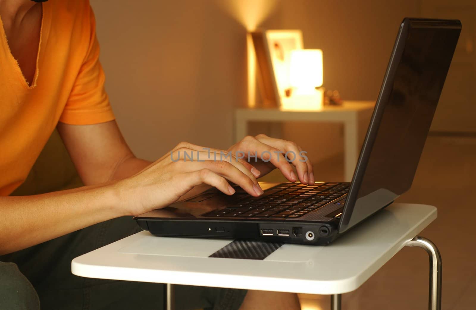 guy working on his laptop at homein the evening