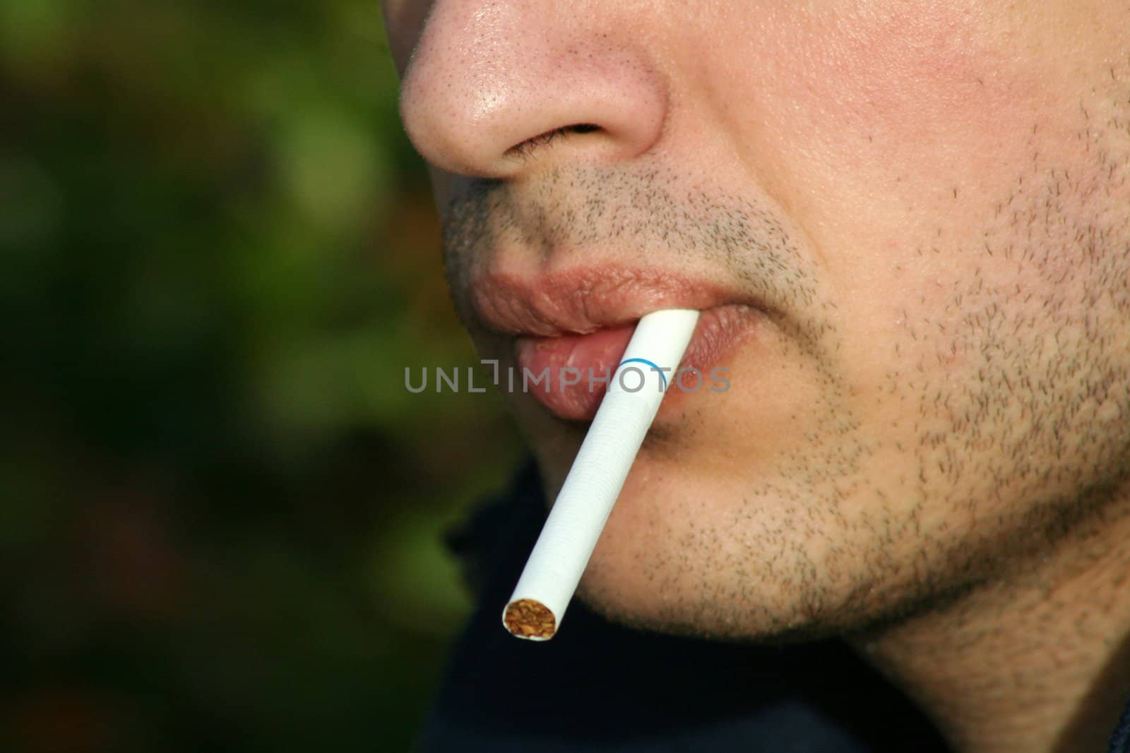 Close up of a person smoking a cigarette.