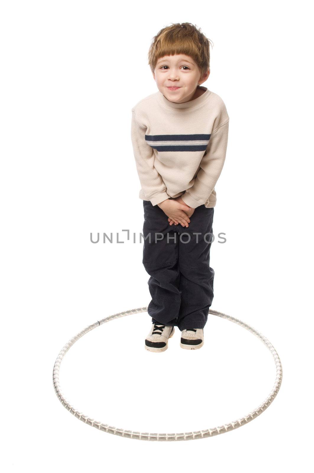 young boy standing and acting silly on a white background