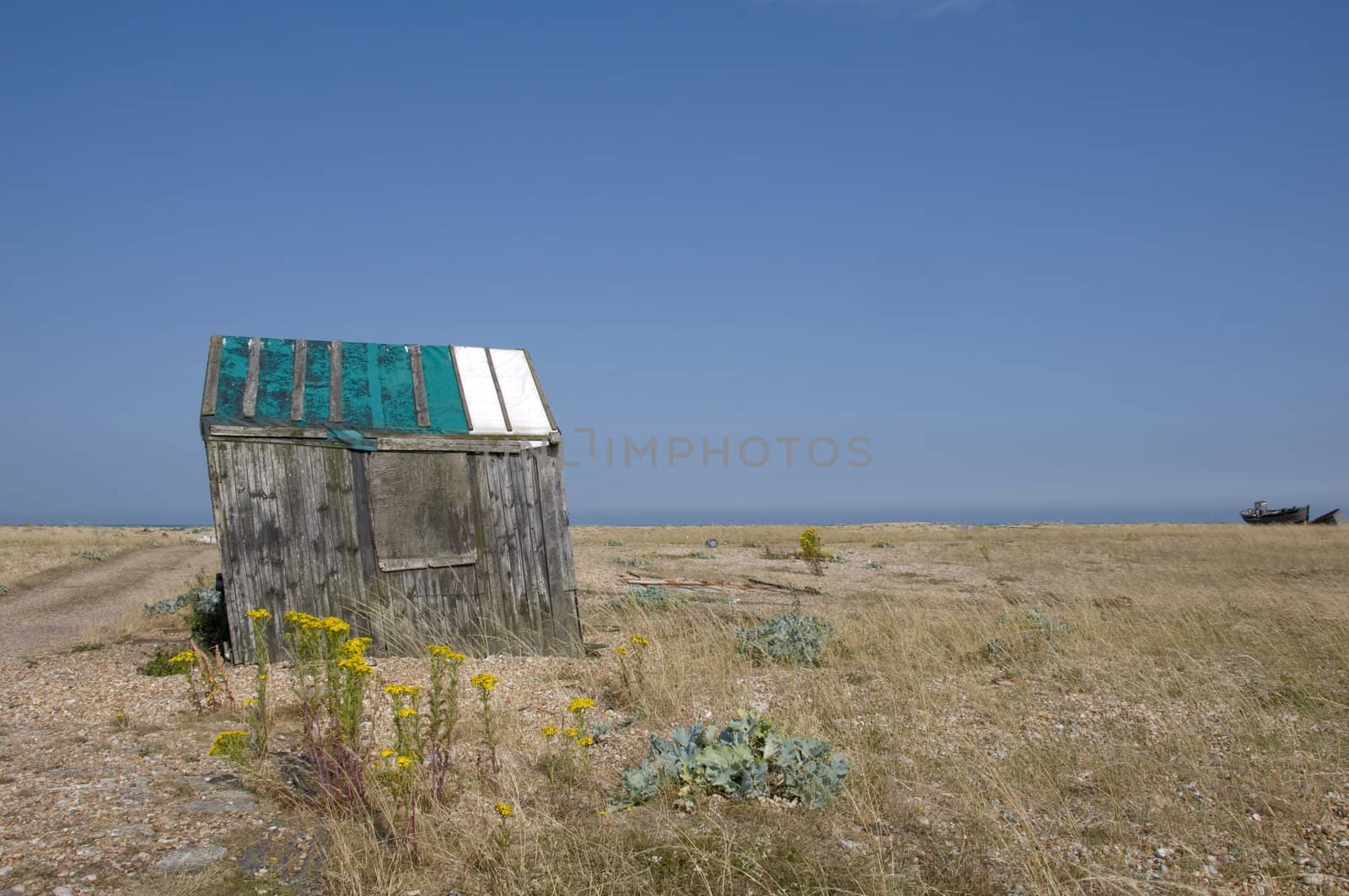 An old abandoned fishing hut on a shingle beach