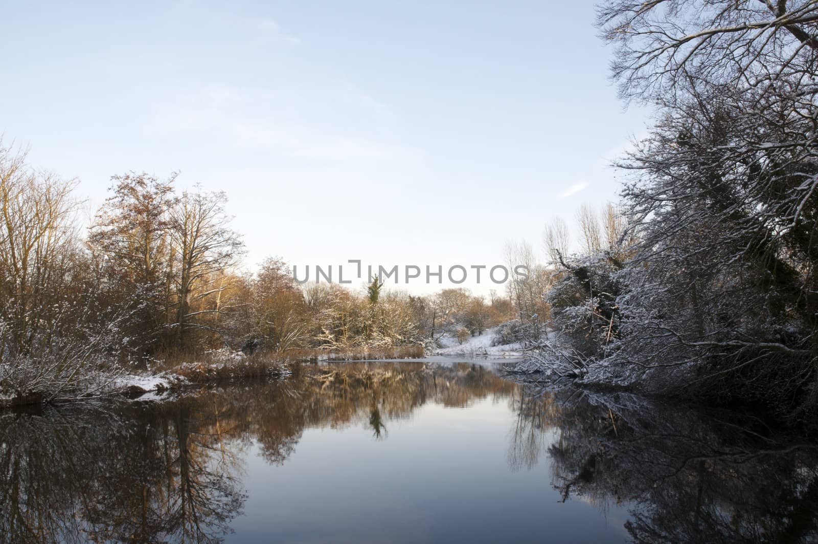 A view of a lake in winter with snow