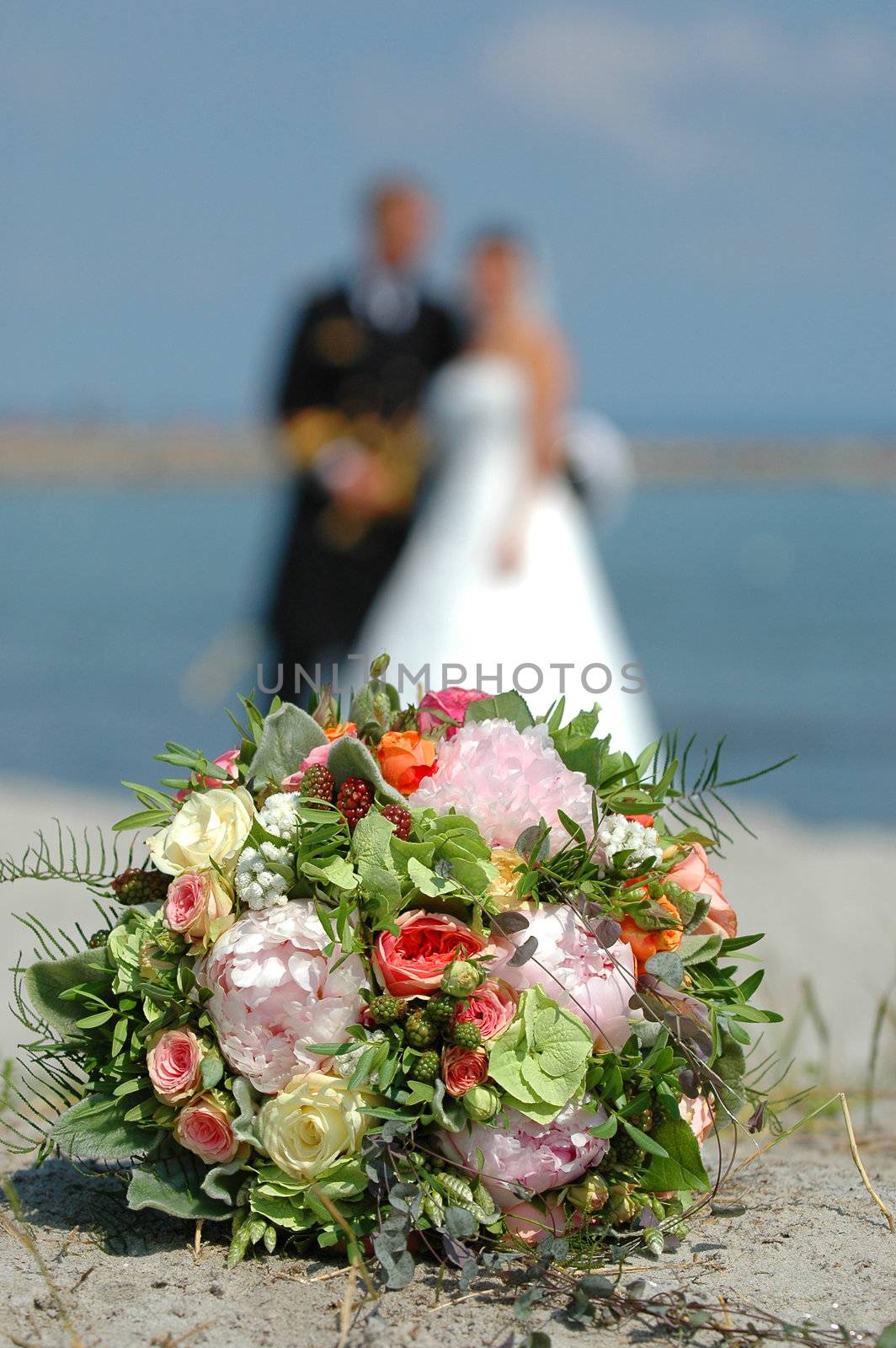 Flower bouquet, bride and groom. Focus on the wedding flower bouquet.
