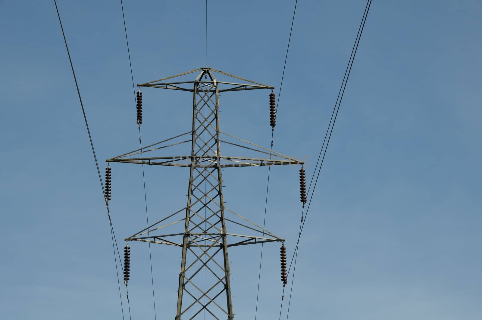 A electrical pylon with a blue sky