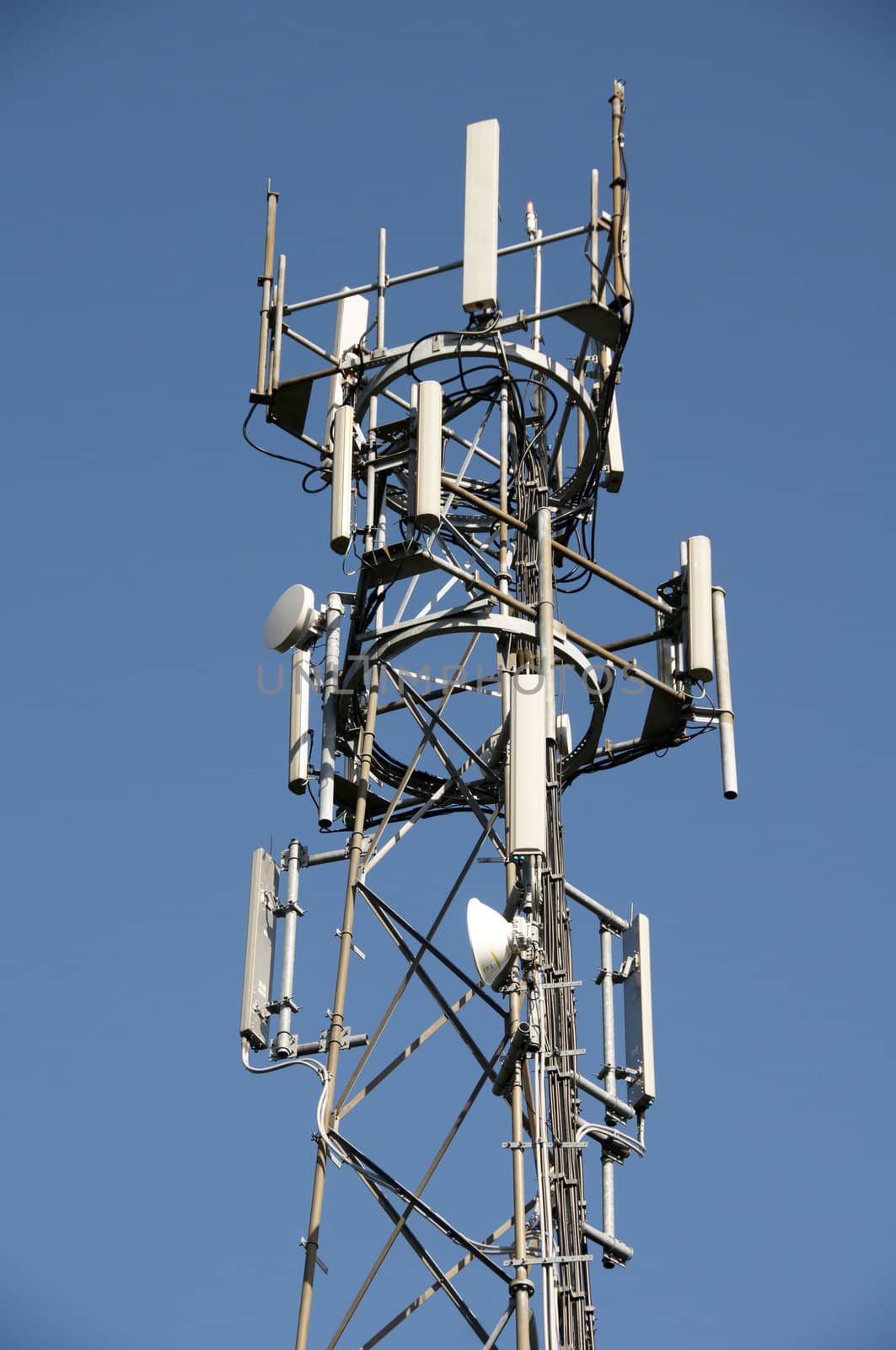 A phone mast against a clear blue sky