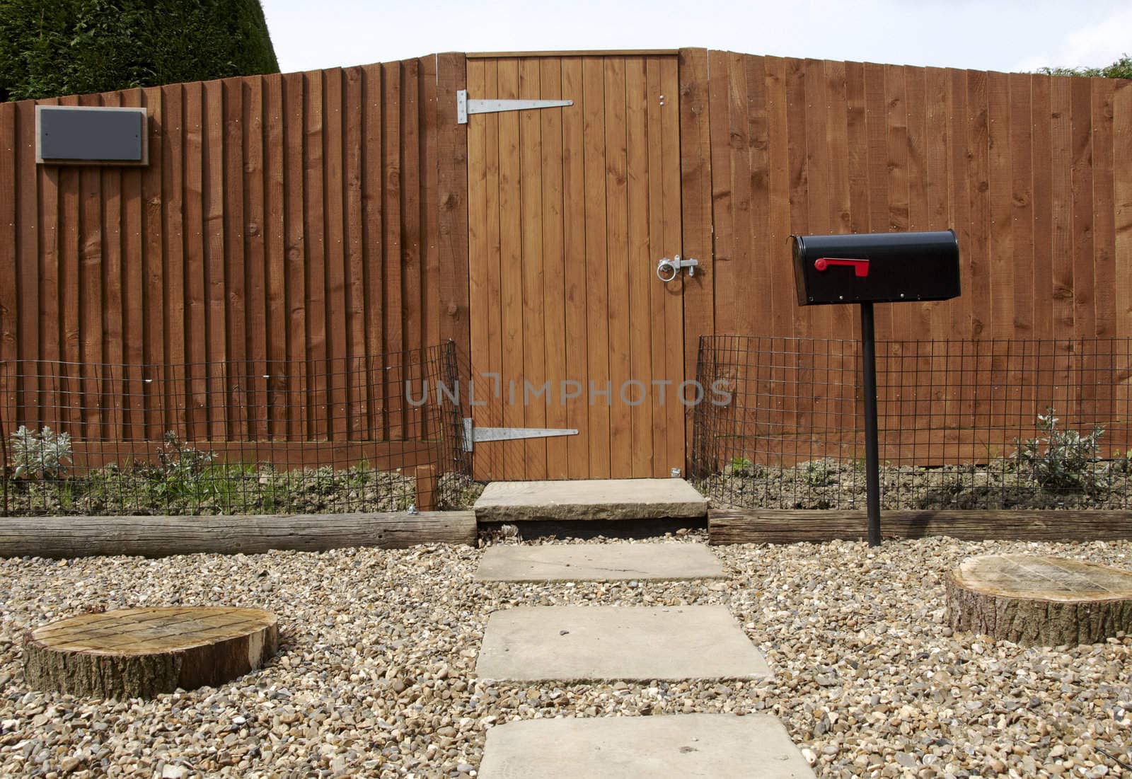 A new wooden fence with a path leading to the gate