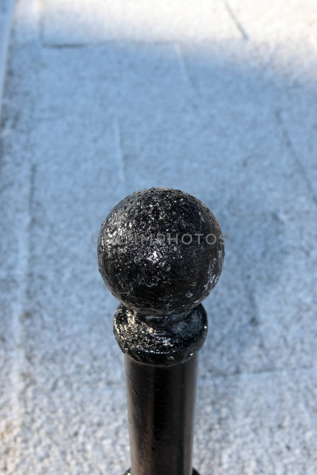 a graphic winters view of a street bollard