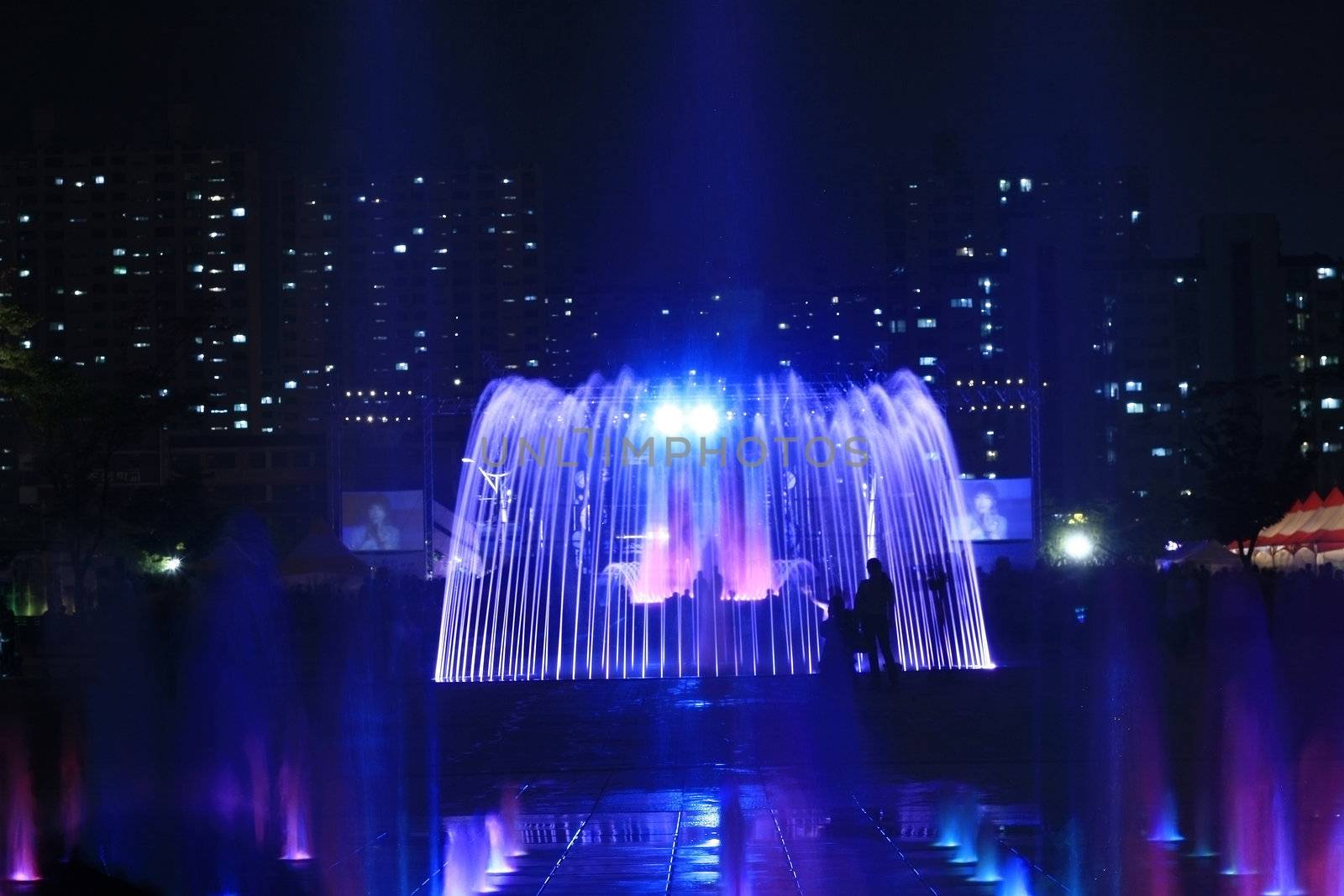 Night Fountain with building lights and tent light in the background