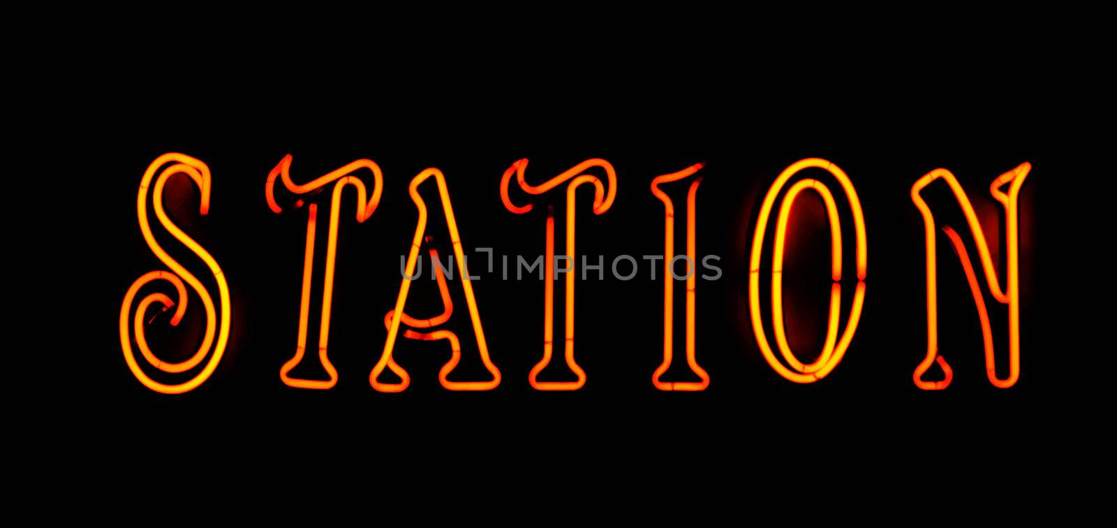 Orange station neon sign on black background