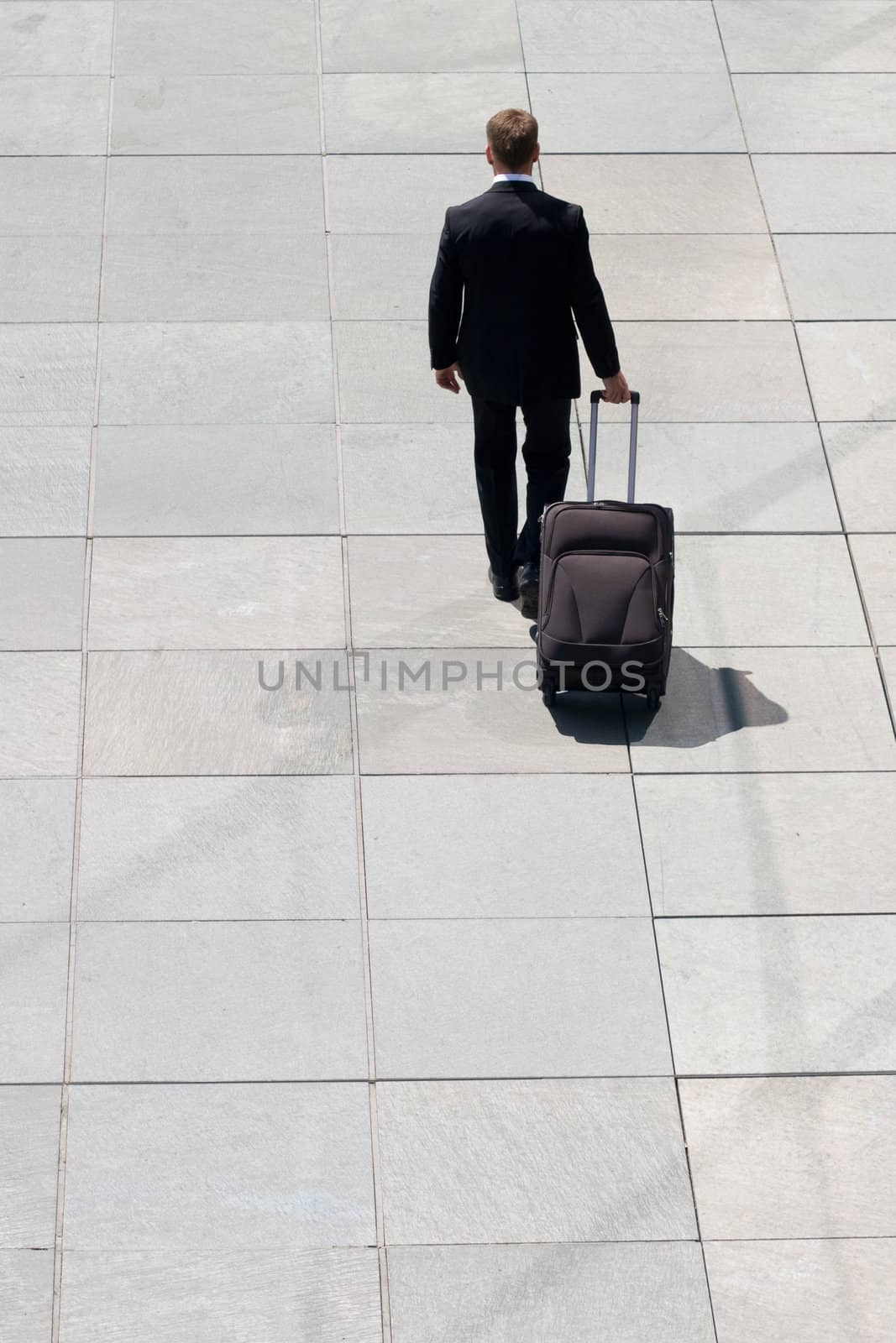 Corporate Man Leaving With Luggage On Pavement