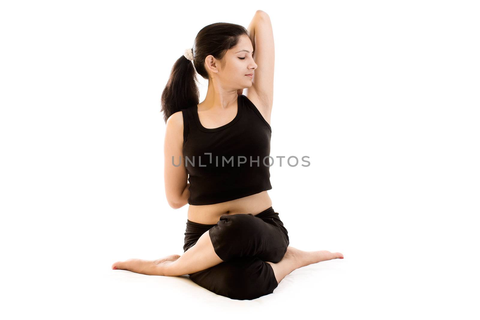 Young woman doing exercise over white background in black dress 