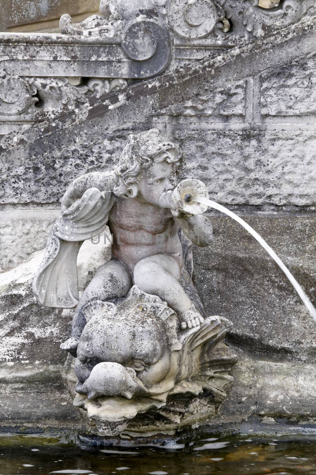 Detail of a  statue of a boy water fountain