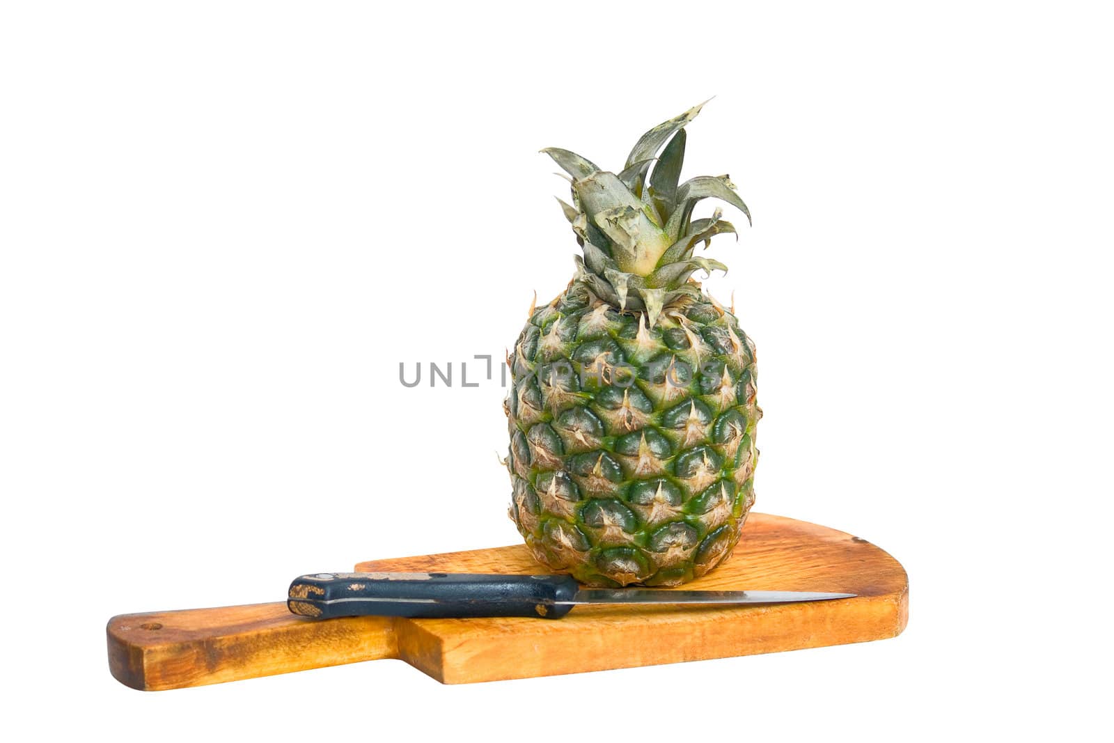 Pineapple, cutting board and knife, isolated on a white background.