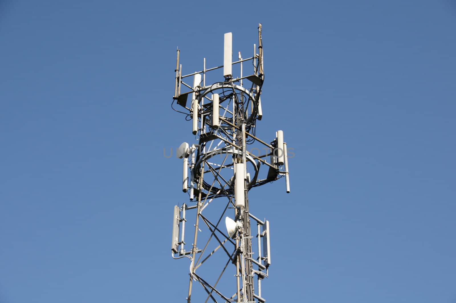 A phone mast against a clear blue sky