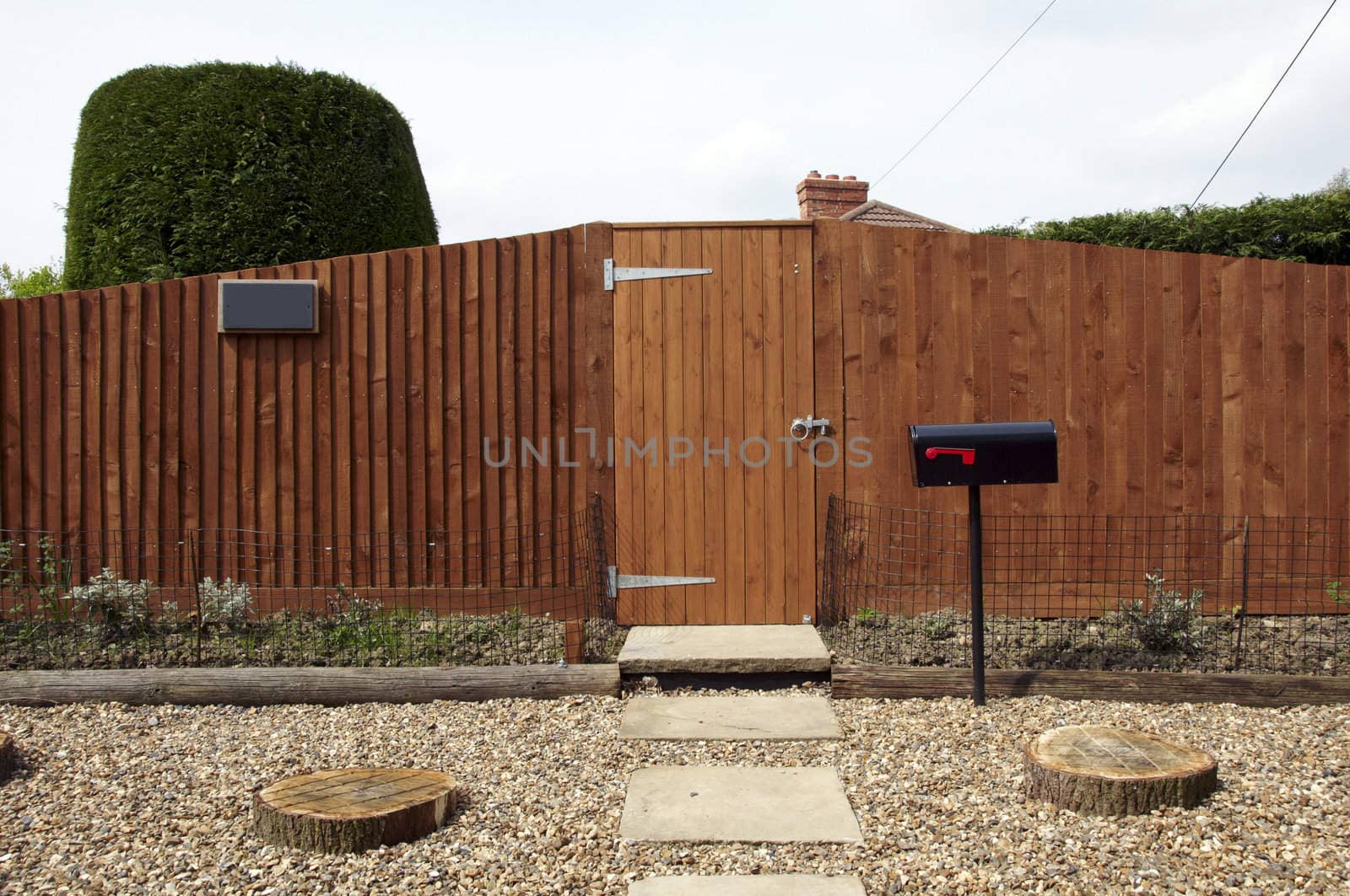 A new wooden fence with a path leading to the gate