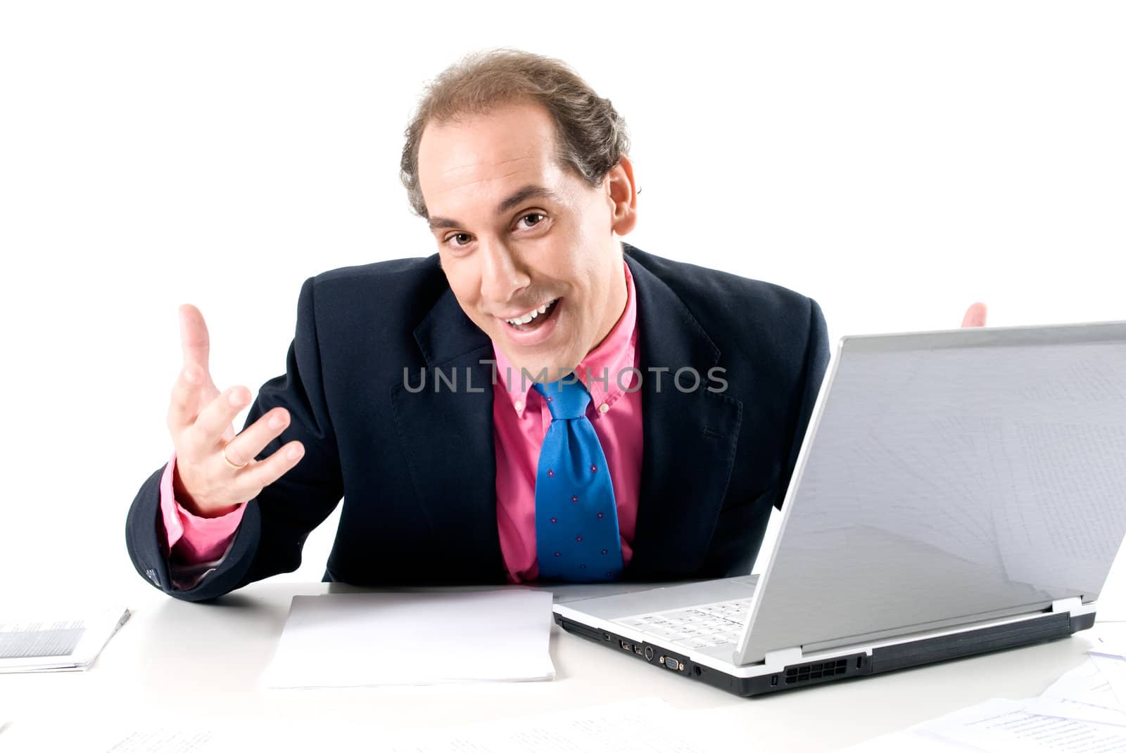 Cheerful businessman with laptop on desk. 