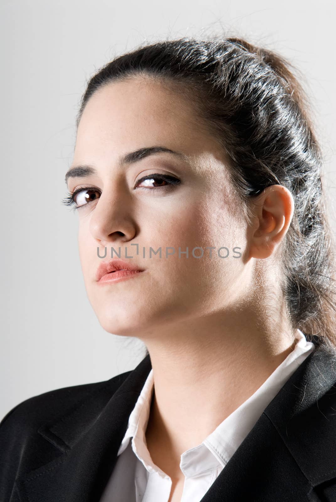 Business woman looking serious by dgmata