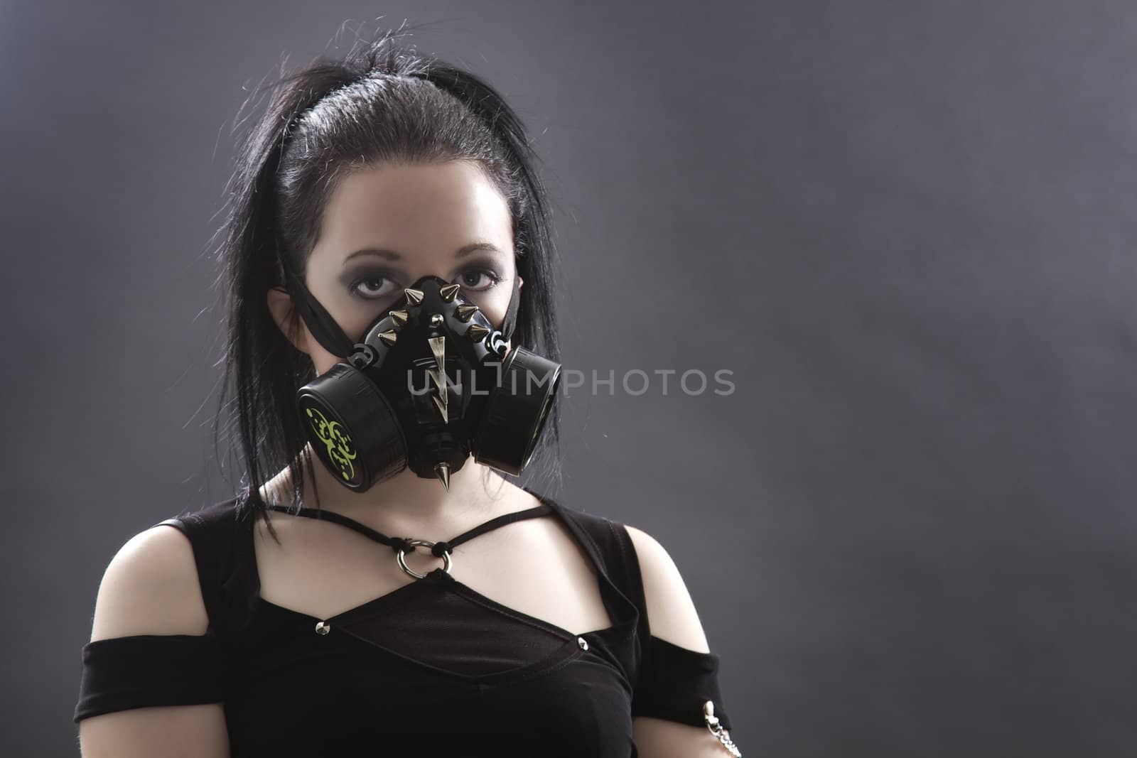 head shot of a teenage girl with black hair and a gas mask