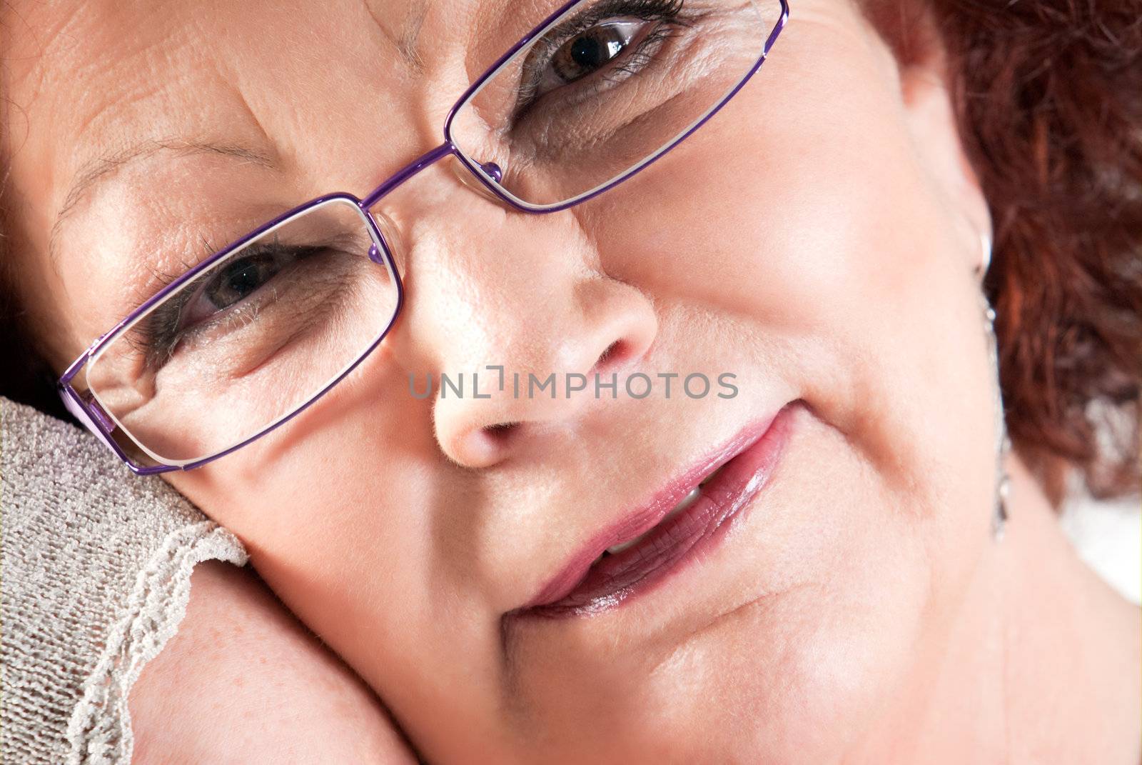 Senior female with glasses smiling closeup portrait