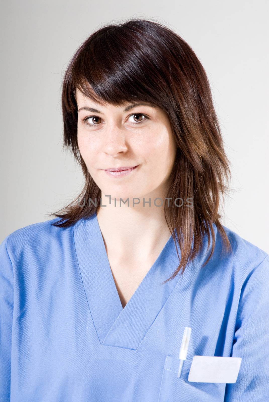 Friendly nurse smiling and looking to camera