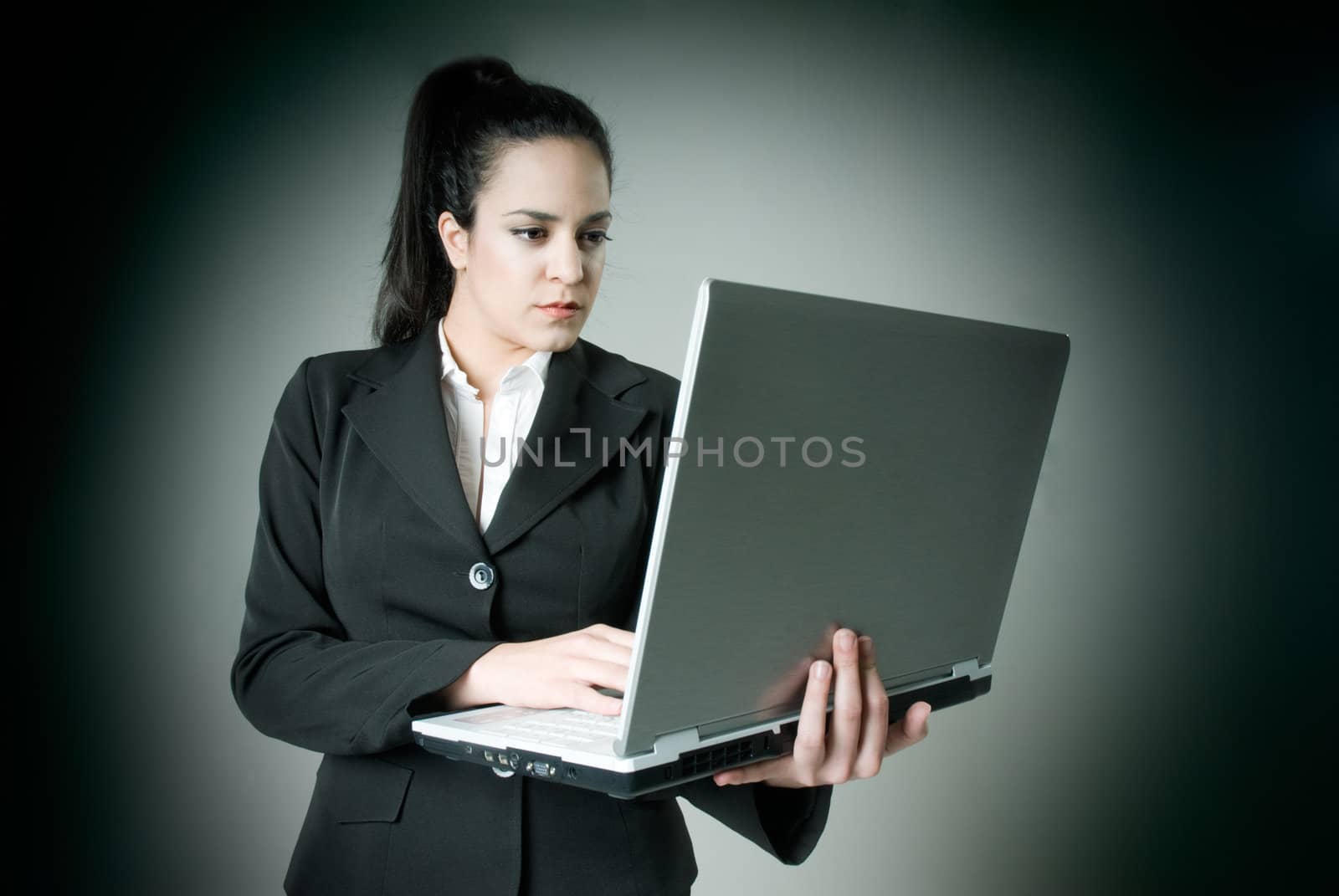 Businesswoman with laptop by dgmata