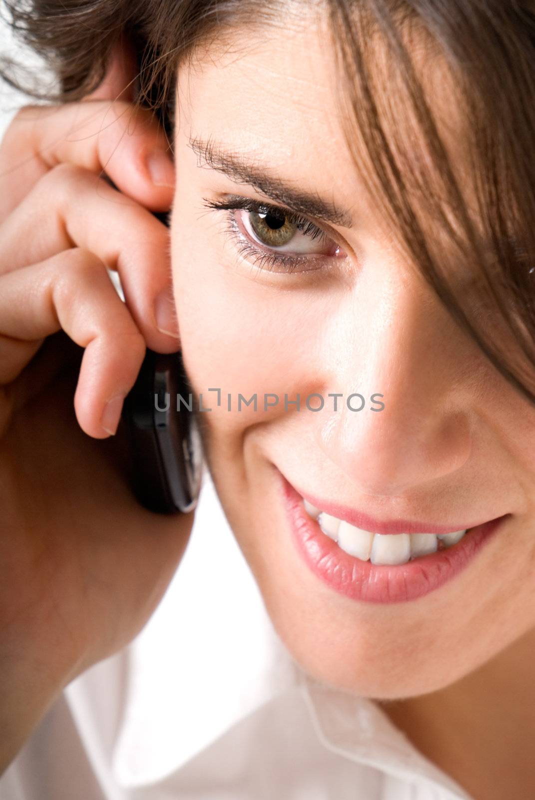 Young woman talking by telephone and smiling