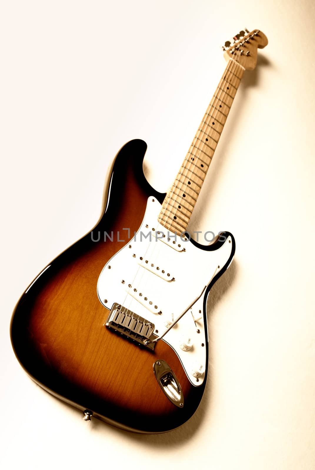 Electric guitar with orange lighting and shallow depth of field.  