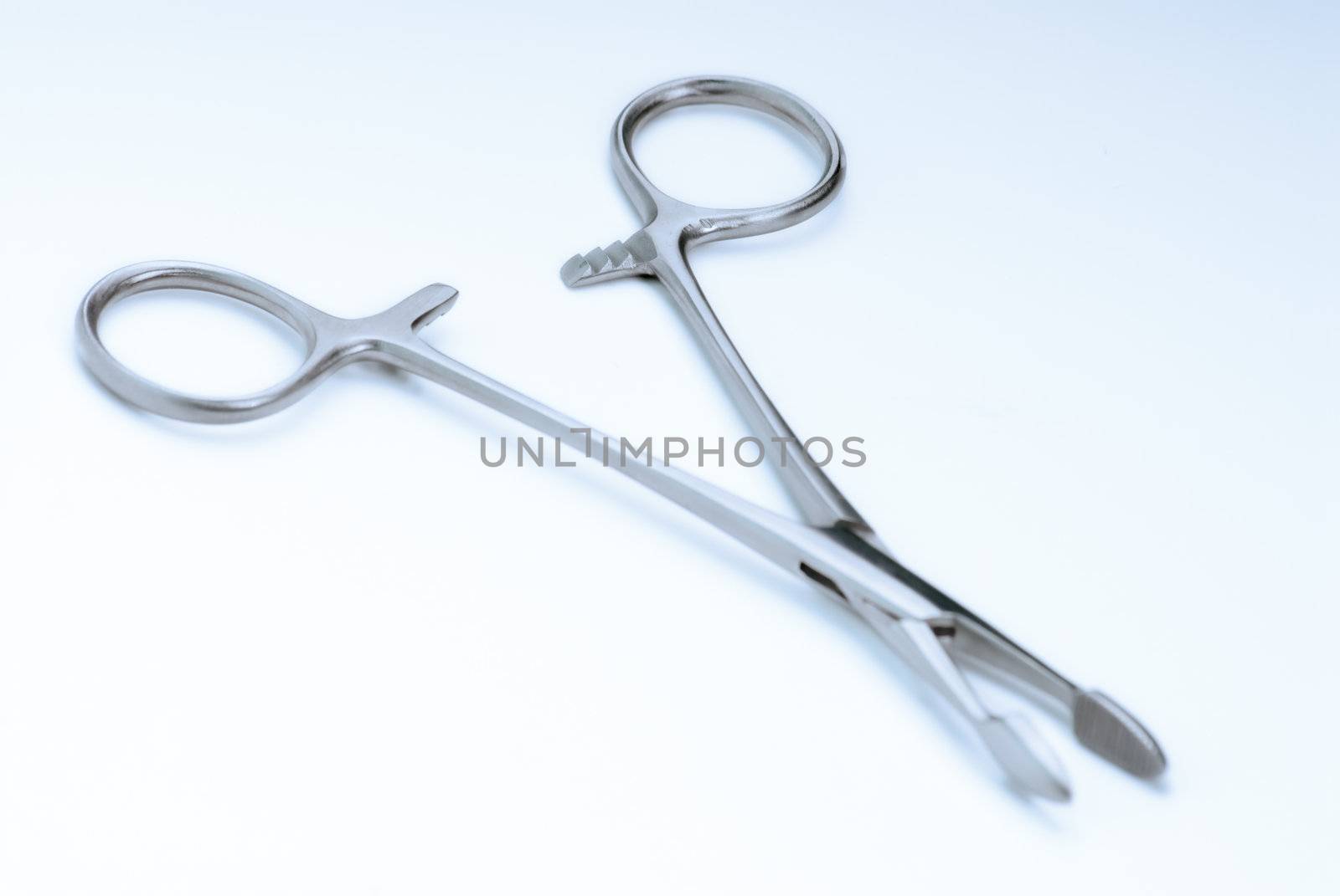 Surgical clamps on a soft blue background "surgical blue"