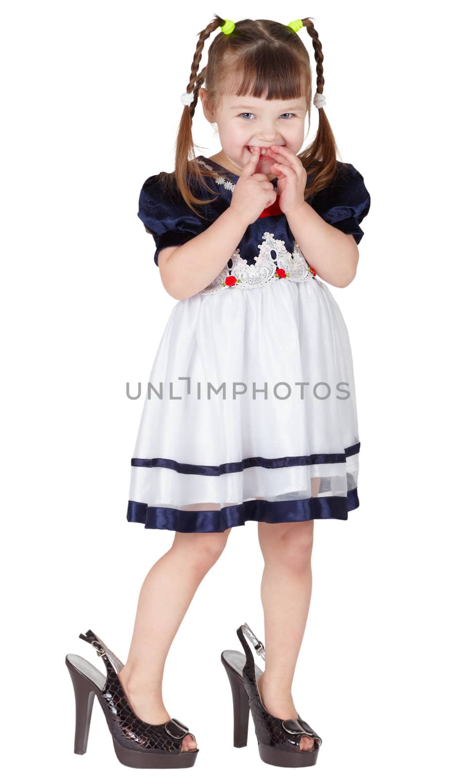 Girl dressed big mama's shoes, isolated on white background