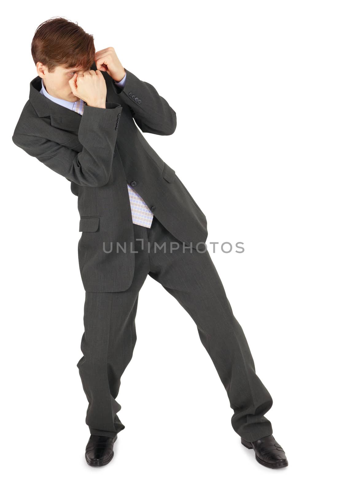 A young businessman parries a blow, isolated on a white background