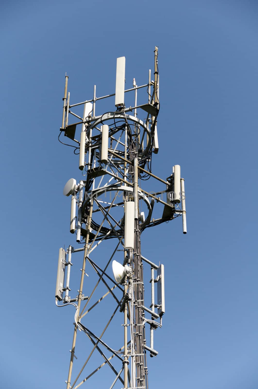 A phone mast against a clear blue sky
